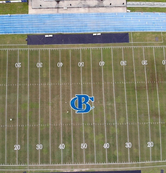 high school football field after striping and logo painting
