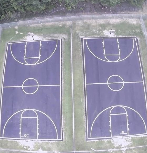 aerial view of two basketball courts freshly painted