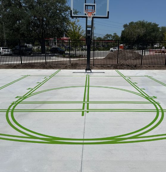 front view of St. Augustine University pickleball court taped up before new line markings