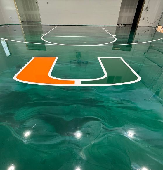 close-up of event logo painted on residential indoor basketball court