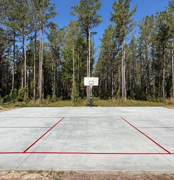 front view of basketball court freshly painted for homeowner