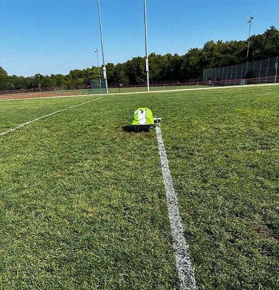 close-up striping machine striping football field