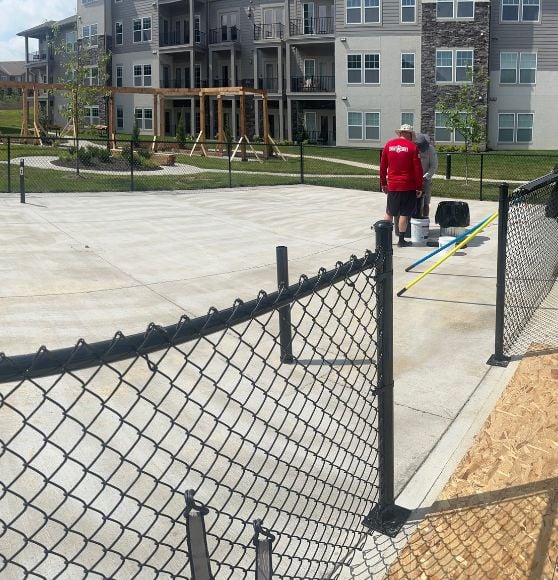 before portrait of a Property Management Group pickleball court with no line markings or paint