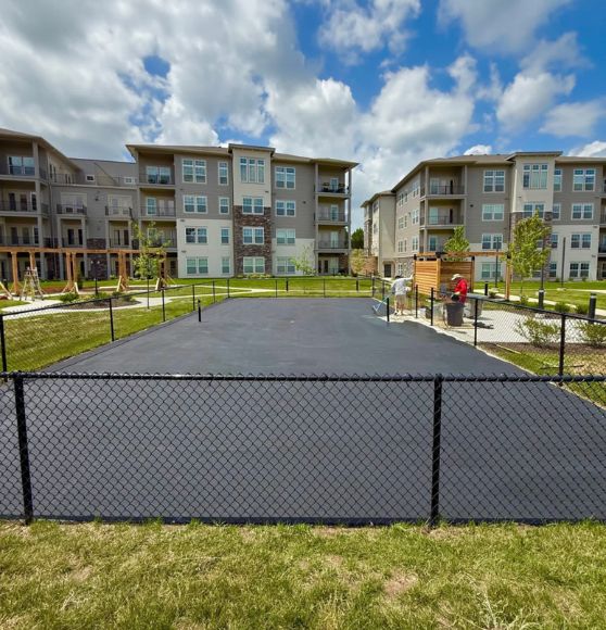 a Property Management Group pickleball court with freshly black asphalt poured