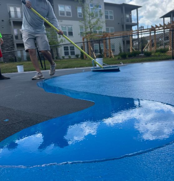 blue paint on pickleball court during process