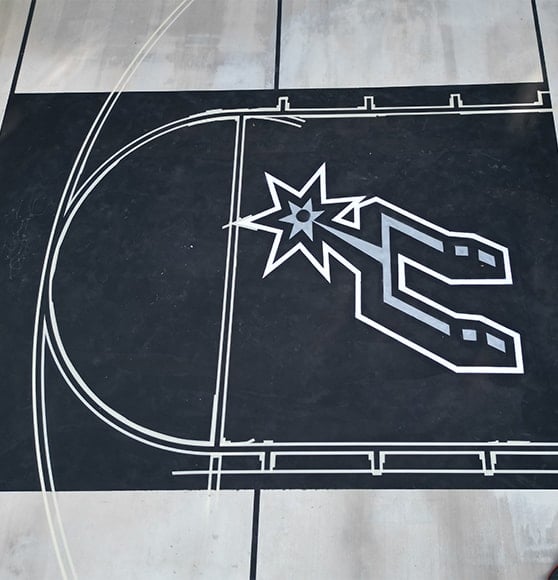 close-up of logo painted on basketball court for homeowner
