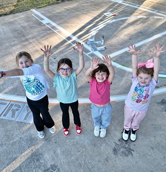 homeowner four daughters smiling on their new basketball court