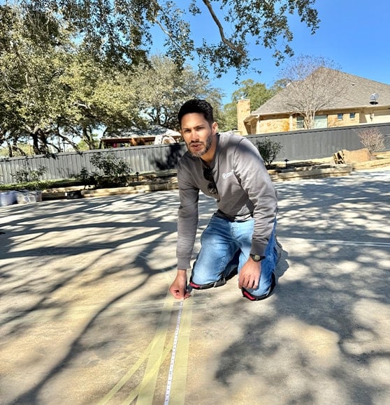 gentleman helping paint new basketball court