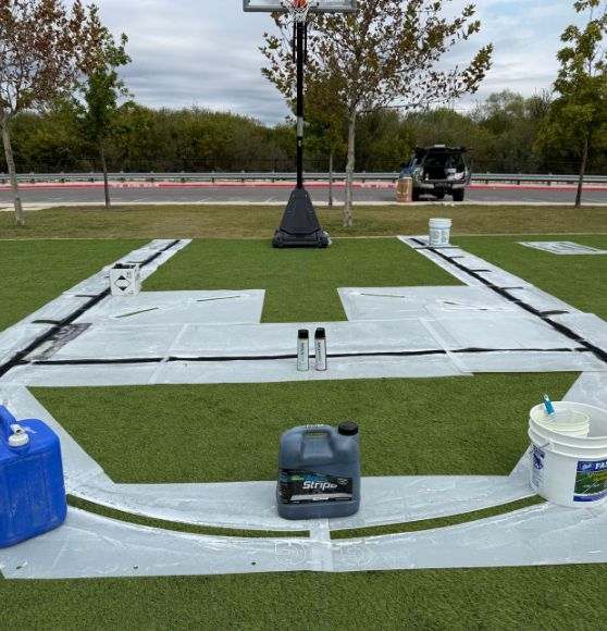 Great Hearts Invictus basketball court in the process of getting painted