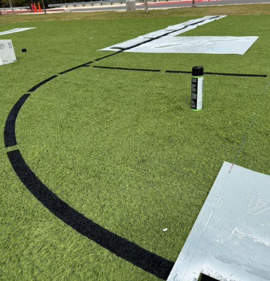 close-up of line markings freshly painted on Great Hearts Invictus basketball court