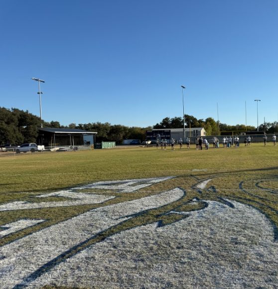 Geneva School field getting logo painted on field