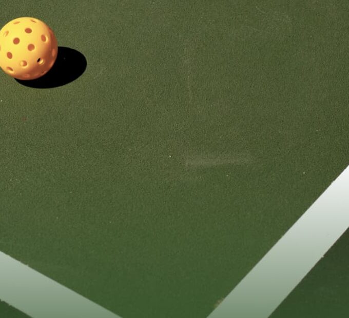 striped pickleball court with pickleball