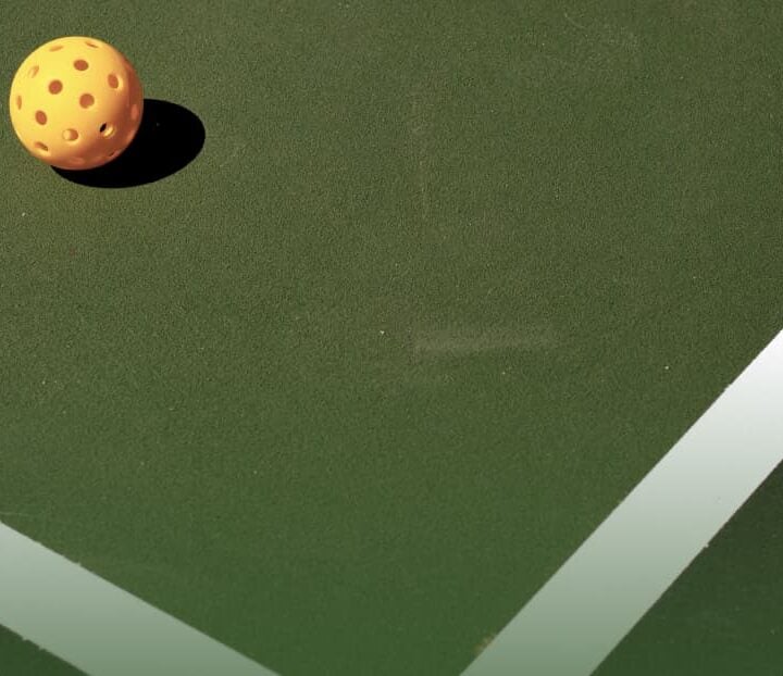 striped pickleball court with pickleball