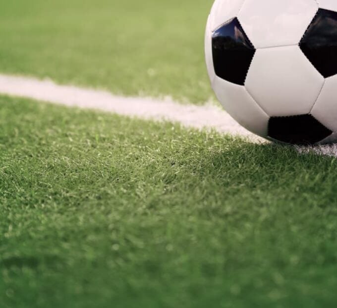 striped soccer field with soccer ball