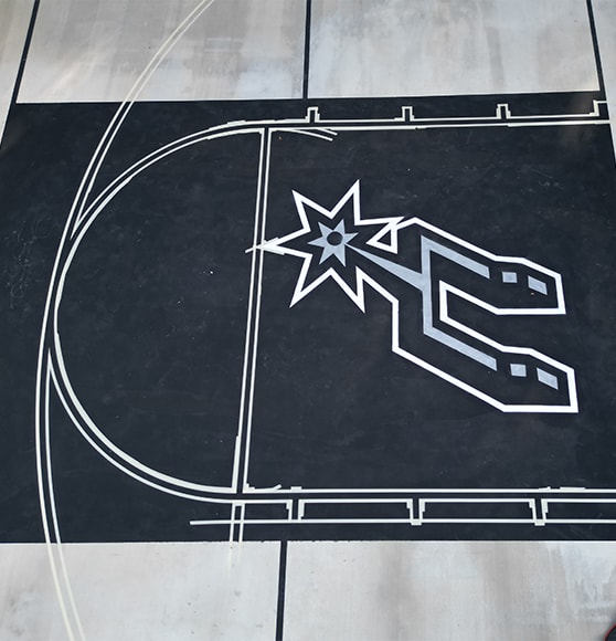 close-up of logo painted on basketball court for homeowner