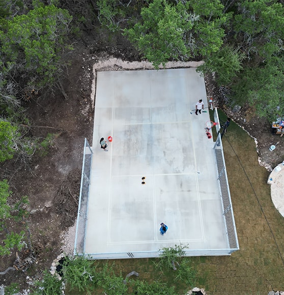 aerial view of homeowner basketball court not painted yet